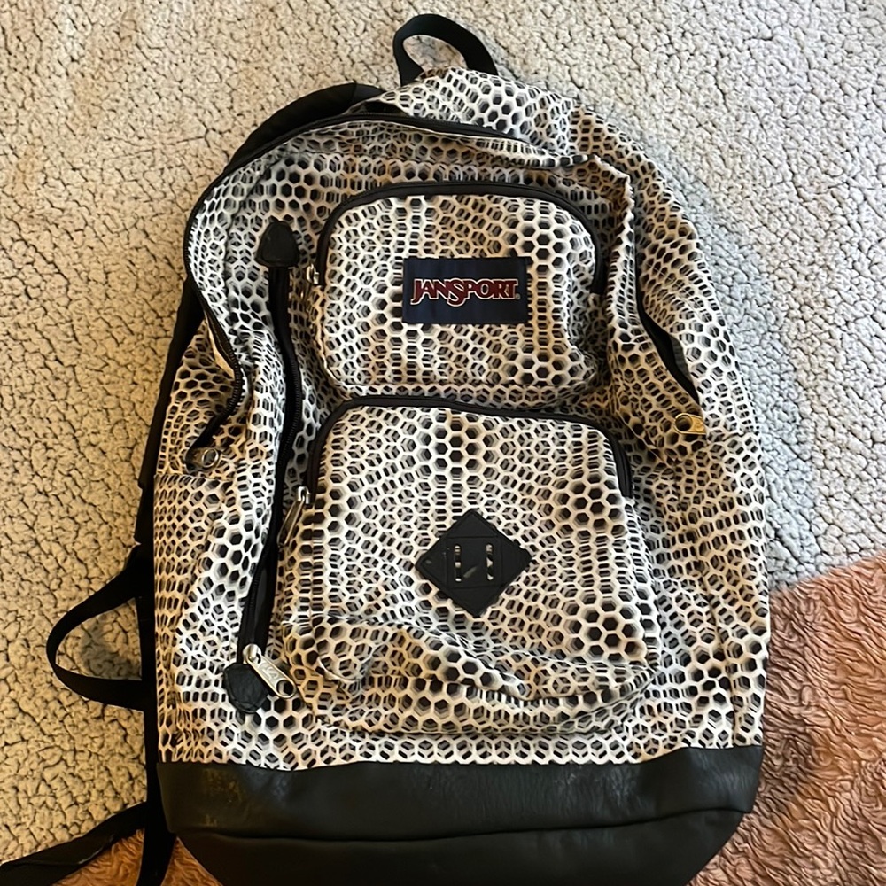 Black and white illusion Jansport school back pack with 4 zipper pockets